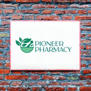 Pioneer Pharmacy logo on a white background on a brick wall